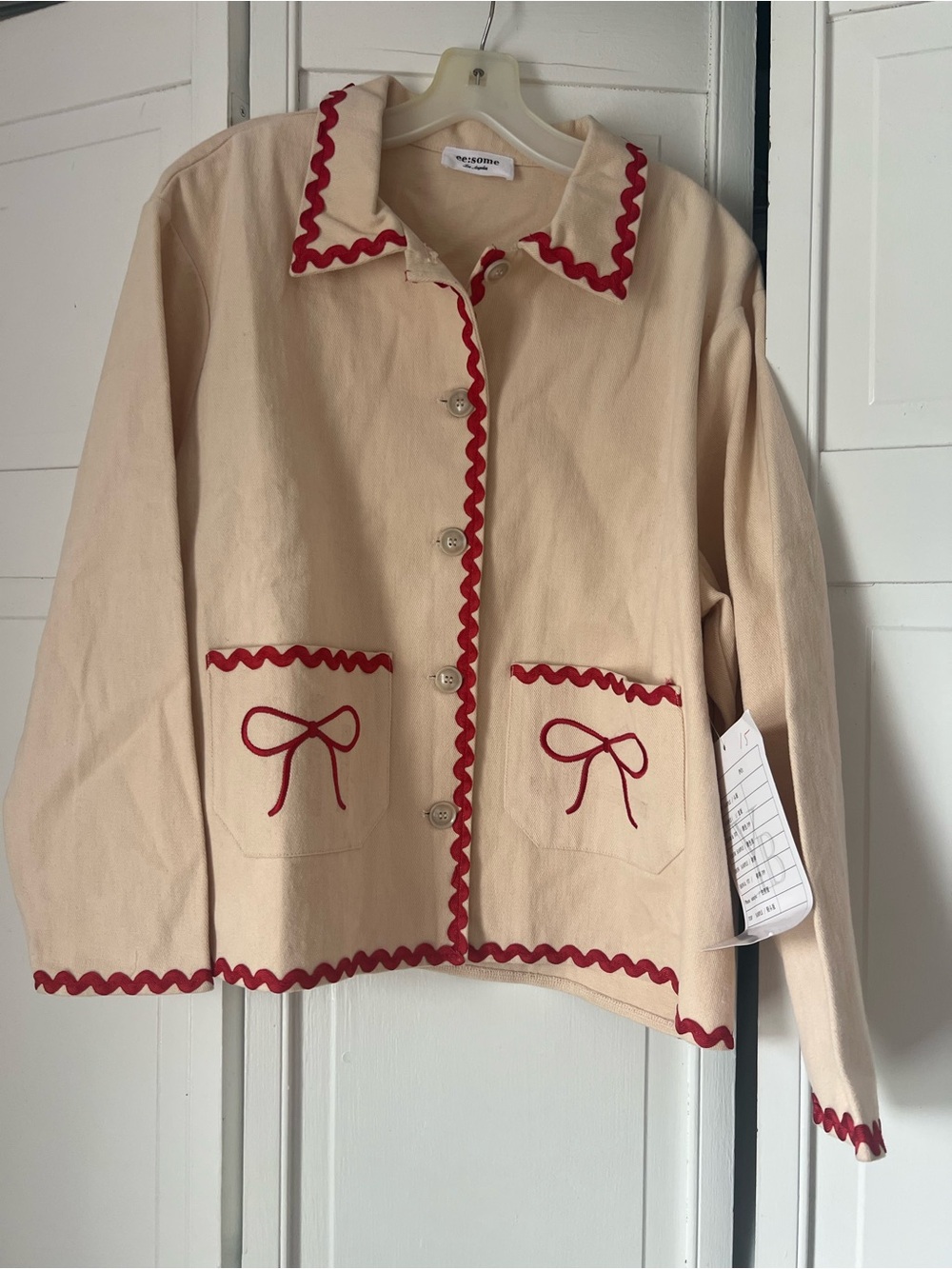 eesome Cream Jacket with Red Ric-Rac Trim and Bow Pocket Detail